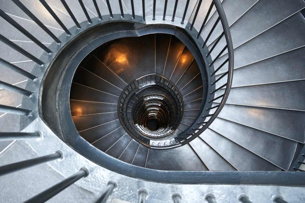 A photo looking down from the top of a spiral staircase